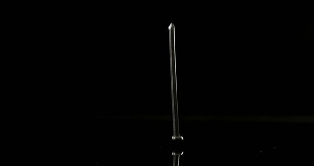 Single Nail Standing Upright on Reflective Surface with Black Background - Download Free Stock Photos Pikwizard.com