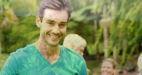 Smiling Man at Outdoor Gathering in Lush Green Garden