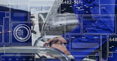 Male professional typing on laptop, futuristic hud dashboards displaying data overlays