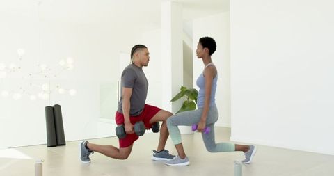 Diverse Fitness Partners Practicing Lunges in Home Exercise Space