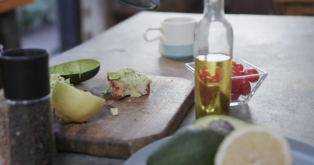 Preparing Fresh Avocado Toast with Oil and Cherry Tomatoes in Kitchen - Download Free Stock Images Pikwizard.com