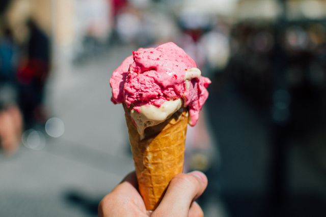 Close-up of Hand Holding Strawberry Ice Cream Cone on Sunny Day - Download Free Stock Photos Pikwizard.com