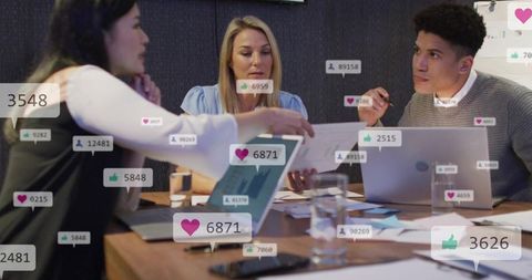 Team collaborating with social media engagement overlays during data-driven boardroom meeting