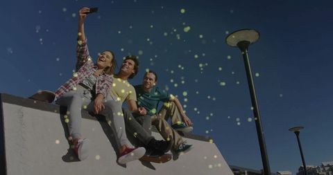 Friends taking selfie on concrete ramp against clear sky