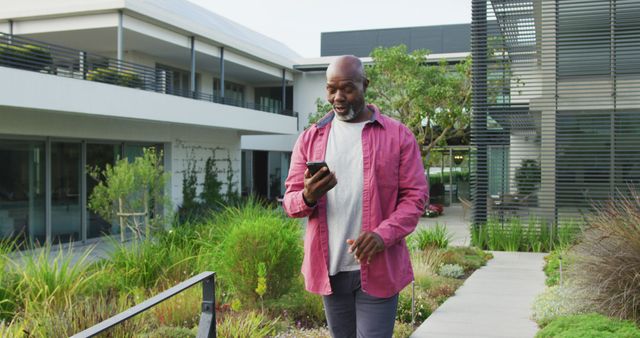 Smiling African American Man Walking in Modern Outdoor Space - Download Free Stock Images Pikwizard.com