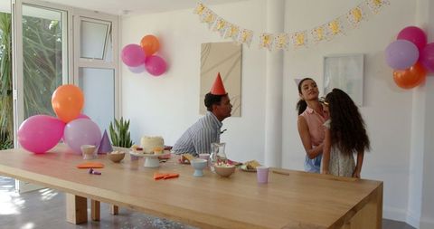 Family Joyfully Celebrating Birthday at Home Together