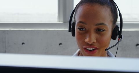 African American Businesswoman Wearing Headset at Office Workstation