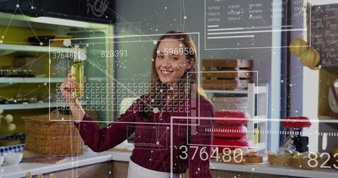 Smiling Woman Holding Cooking Oil with Digital Data Overlays in Modern Kitchen
