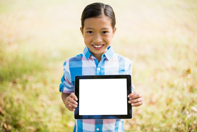 Child Smiling Holding Transparent Screen in Park - Download Free Stock Videos Pikwizard.com