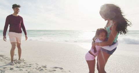 Family Enjoying Beach Day with Laughter and Joy - Download Free Stock Images Pikwizard.com