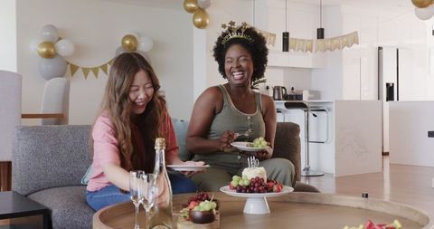Joyful Couple Celebrating Indoor Birthday with Food and Drinks