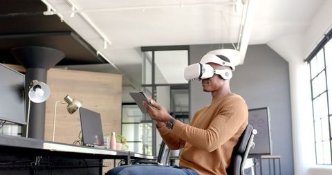 Man Exploring VR Technology at Office Workstation