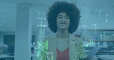 Confident businesswoman holding documents in modern open-plan office with finance data overlay