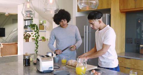 Friends Preparing Breakfast Together in Sunny Modern Kitchen