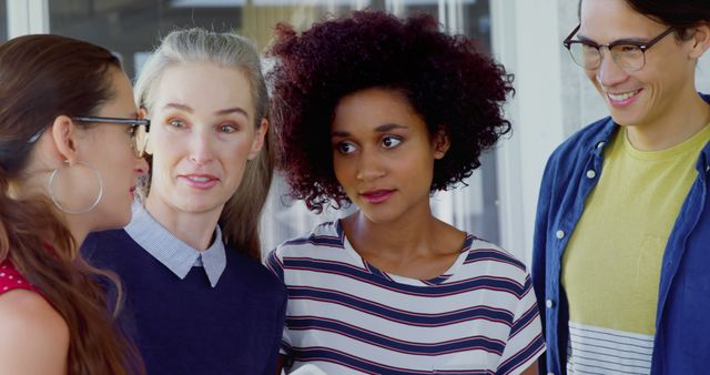 Group of diverse friends discussing, smiling, and enjoying each other's company outdoors. Perfect for themes related to social interaction, camaraderie, friendship, diversity, and happiness. Suitable for use in advertising, magazines, websites, and community-building materials.