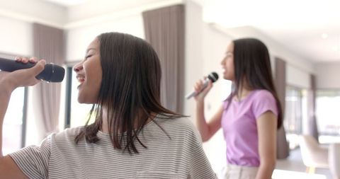 Teenage Girls Enjoying Karaoke Music Together at Home - Download Free Stock Images Pikwizard.com