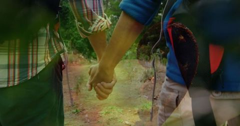 Couple Holding Hands on Forest Hiking Adventure