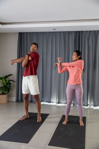 Couple Engaging in a Home Stretch Routine on Yoga Mats