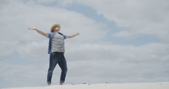 Joyful Man with Hat Enjoying Freedom at Beach - Download Free Stock Images Pikwizard.com