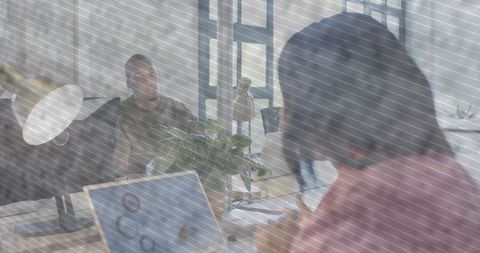 Remote-style woman multitasking with smartphone and laptop in modern coworking office