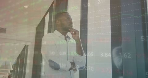 Pensive African American Man Overlooking Stock Market Ticker