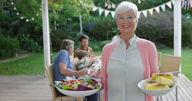 Senior Woman Hosting Family Garden Party with Healthy Meal - Download Free Stock Images Pikwizard.com