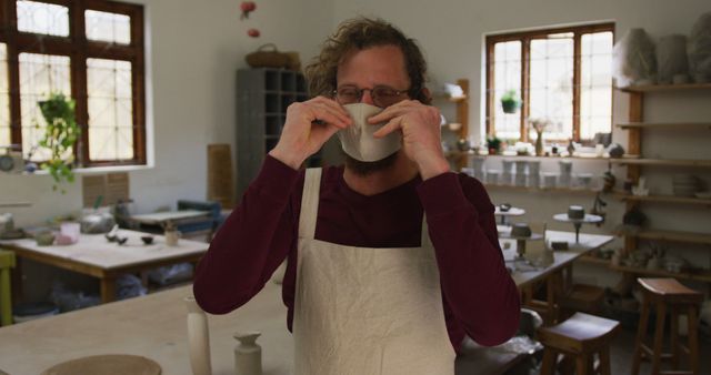 Male Potter in Home Studio Wearing Apron Adjusting Face Mask - Download Free Stock Images Pikwizard.com