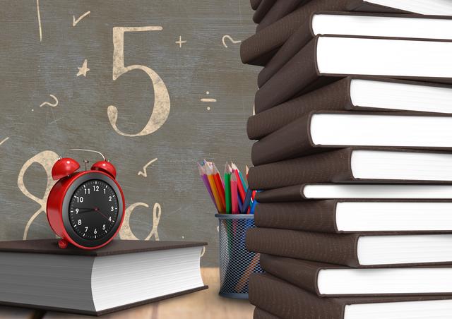 Alarm clock on a book with number and mathematical symbols on chalkboard in background - Download Free Stock Photos Pikwizard.com