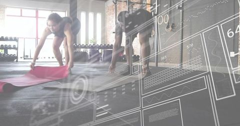 Duo unrolling yoga mats in industrial gym with tech data overlay for smart training