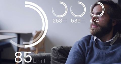 Contemplative man on couch with futuristic HUD overlays for tech thinking and wellness