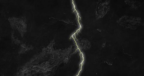 Powerful yellow lightning bolts split black sky