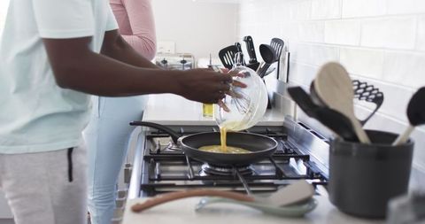 Couple Cooking Breakfast in Modern Kitchen at Home