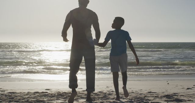 Father and Son Walking Together on Beach at Sunset - Download Free Stock Images Pikwizard.com