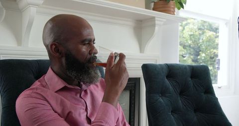 Man Relaxing in Elegant Living Room with Beverage