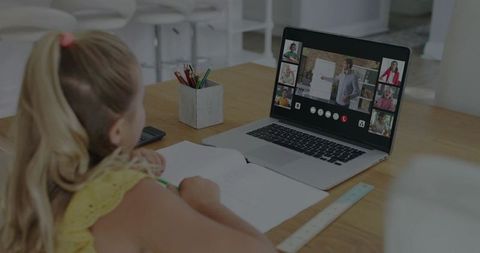 Young Girl Doing Remote Learning at Home Watching Teacher Present on Laptop