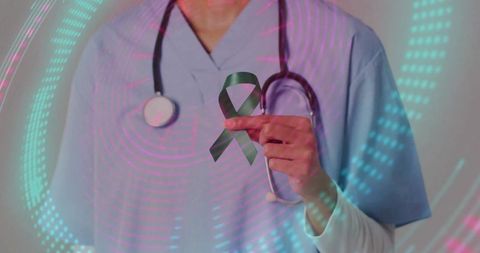 Nurse holding green awareness ribbon with digital overlay