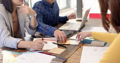 Creative Design Team Collaborating in Modern Studio Workspace