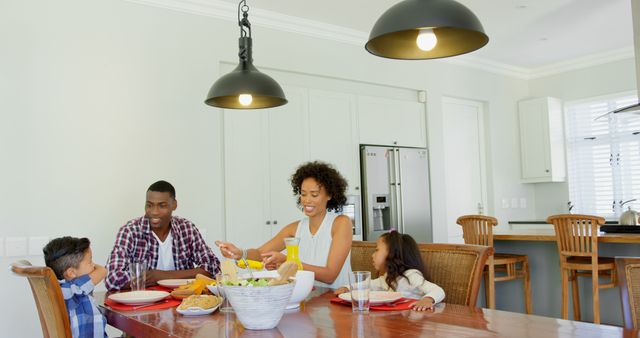 Black family eating food on dining table at home. Black family interacting with each other 4k