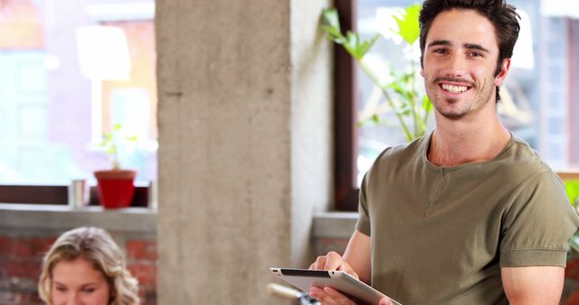 Smiling Man Using Tablet in Modern Office - Download Free Stock Images Pikwizard.com