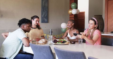 Friends Sharing Meal and Laughter at Home