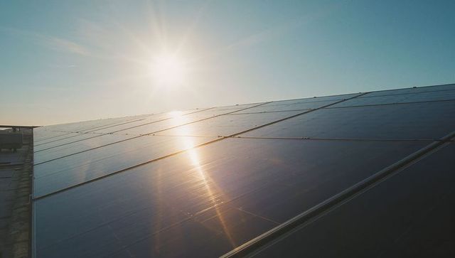 Sunlight Reflecting on Solar Panel Rooftop in Scenic Sunrise