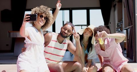 Diverse group of friends taking selfie, enjoying summer fun