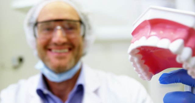 Portrait of dentist holding a mouth model in dental clinic 4k
