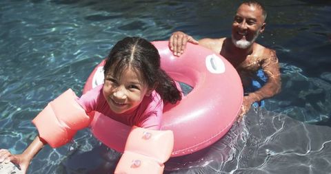 Grandfather and Granddaughter Bonding in Swimming Pool, Summer Fun
