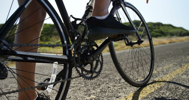 Cyclist Pedaling on Open Road During Sunny Day - Download Free Stock Images Pikwizard.com