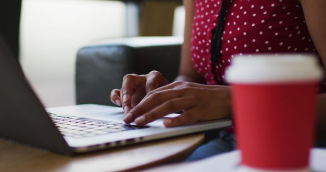 Person Typing on a Laptop with Red Coffee Cup in Foreground - Download Free Stock Images Pikwizard.com