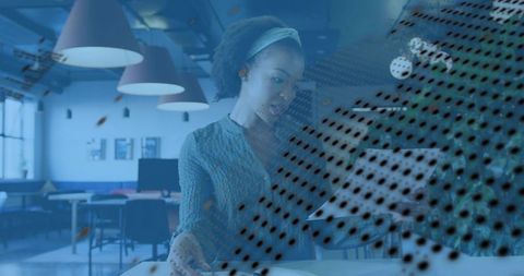 Woman using tablet in modern coworking space with abstract dot overlay