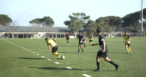 Intense Soccer Match Action with Athletes Competing for Ball