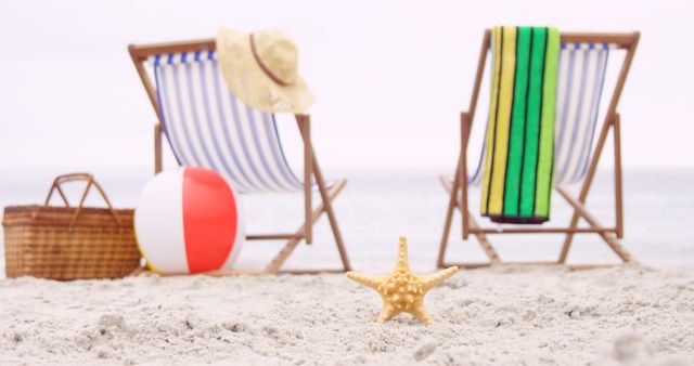 Relaxing Beach Setup with Chairs, Towel, Hat, Basket, and Starfish Focus - Download Free Stock Images Pikwizard.com