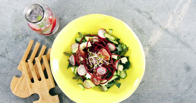 Fresh Vegan Salad with Beetroot Spiral in Vibrant Yellow Bowl - Download Free Stock Images Pikwizard.com